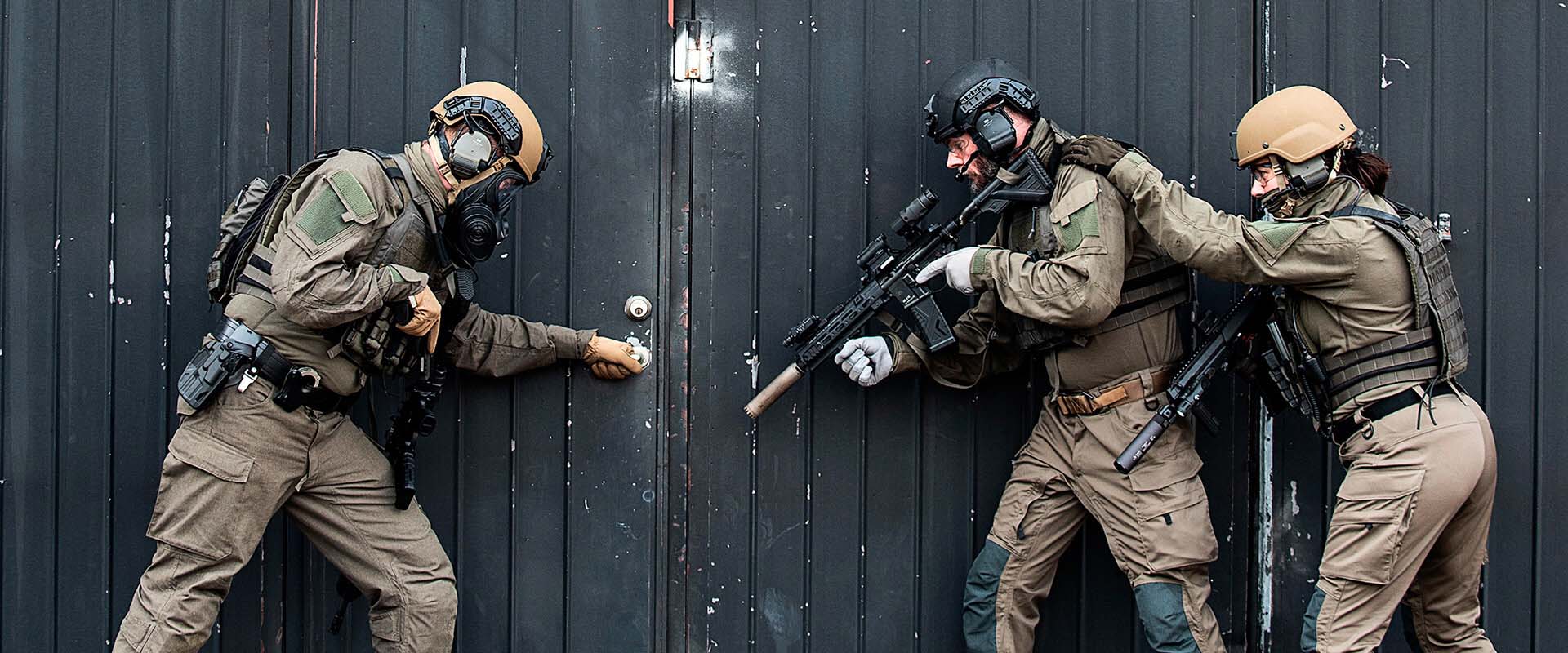 Police law enforcement personnel at door wearing Torraka tactical clothing and uniform system